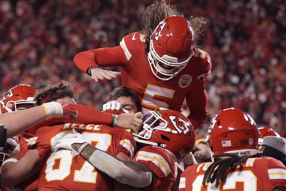 Kansas City Chiefs tight end Travis Kelce (87) celebrates with teammates after catching an 8-ya ...