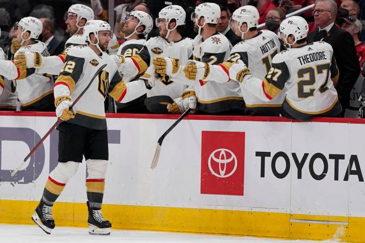 Vegas Golden Knights center Michael Amadio (22) is congratulated by teammates after scoring a g ...