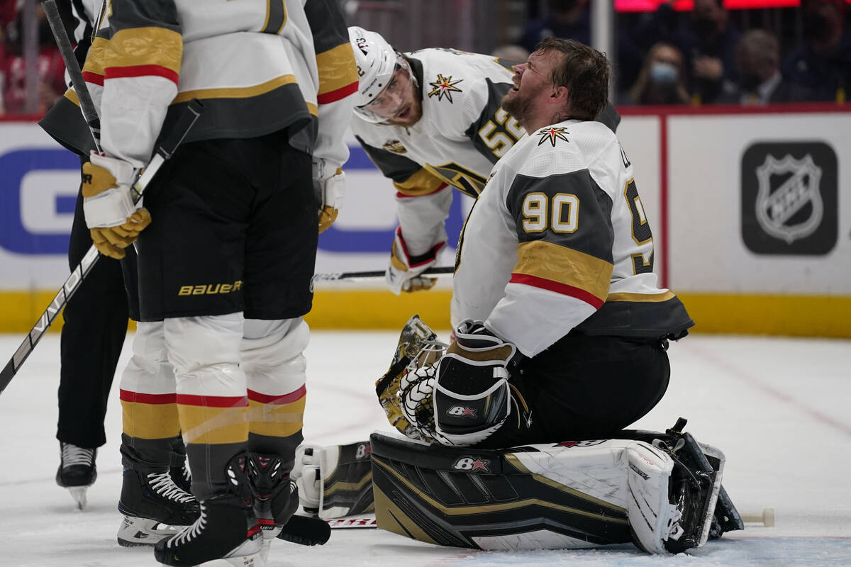 Vegas Golden Knights defenseman Dylan Coghlan (52) checks on Golden Knights goaltender Robin Le ...