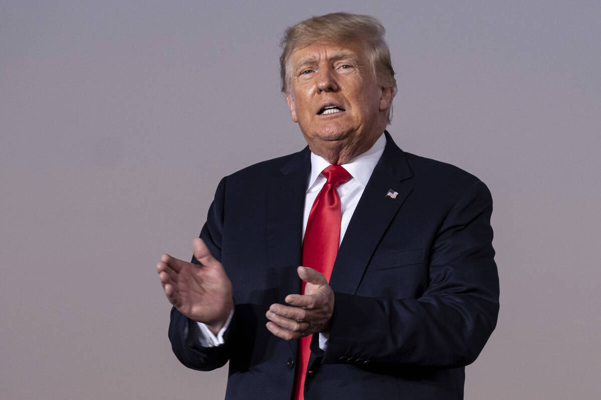 FILE - Former President Donald Trump prepares to take the stage during a rally in Perry, Ga., o ...