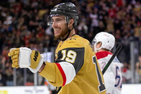Golden Knights right wing Reilly Smith (19) skates to celebrate with center Jonathan Marchessau ...
