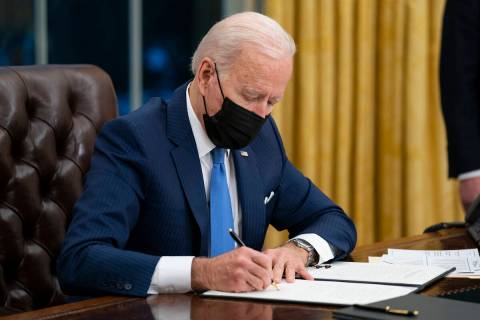 President Joe Biden signs an executive order. (AP Photo/Evan Vucci, File)