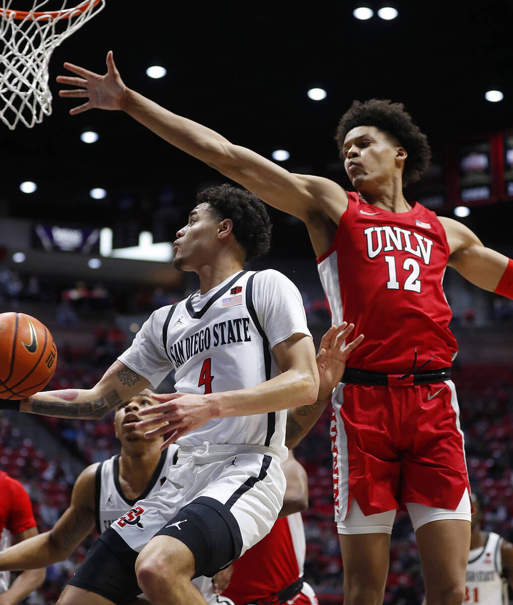 San Diego State's Trey Pulliam (4) shoots around UNLV's David Muoka (12) during an NCAA college ...