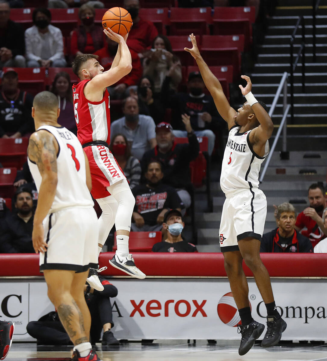 UNLV's Jordan McCabe shoots against San Diego State's Lamont Butler during an NCAA college bask ...