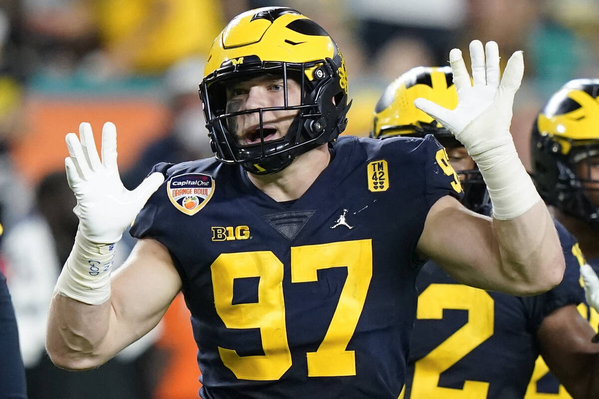 Michigan defensive end Aidan Hutchinson gestures during the first half of the Orange Bowl NCAA ...