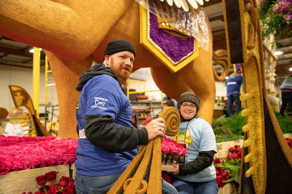 Aaron and Jennifer Bush work on the Donate Life float for Saturday's Tournament of Roses parade ...