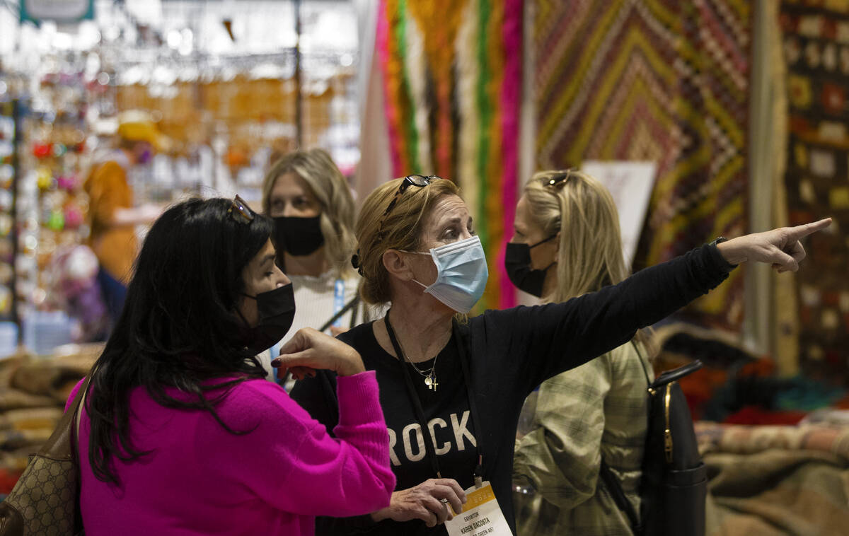Karen Dacosta, right, with Forever Green Art, talks with shoppers during the Las Vegas Market a ...