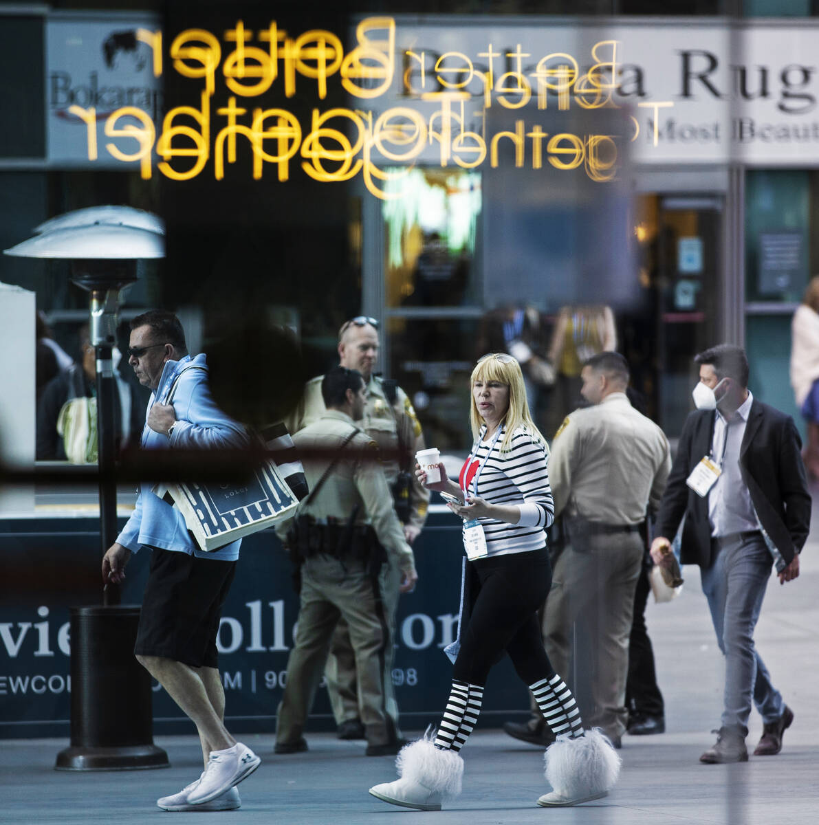 Conventiongoers walk in the courtyard during the Las Vegas Market at World Market Center Las Ve ...