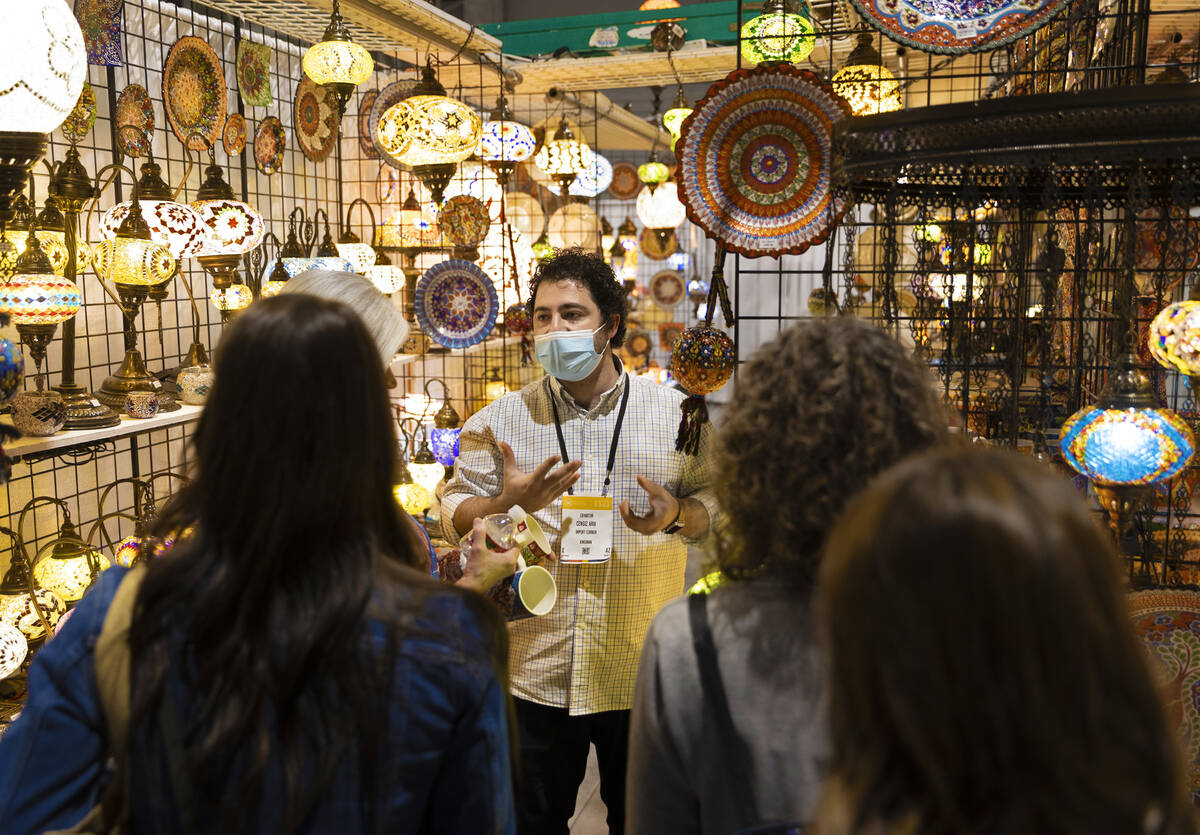 Cengiz Arik, middle, with Import Corner, talks with conventiongoers during the Las Vegas Market ...