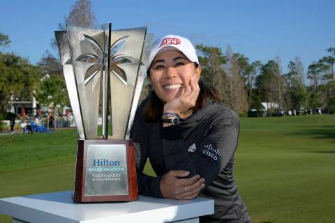 Danielle Kang poses next to the championship trophy on the 18th green after winning the Tournam ...
