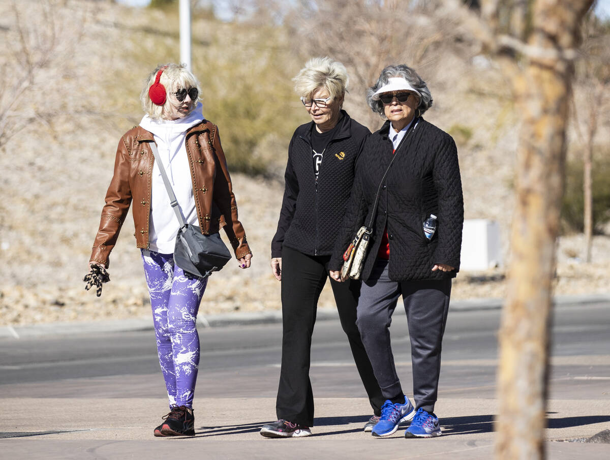 Pat Santz, left, Gail Ellis and Juana Miller, all of Henderson, are bundled up as they walk dur ...