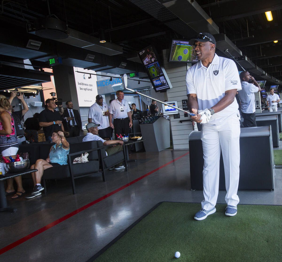 Former Oakland Raiders wide receiver Tim Brown gets ready to swing during the Raiders Foundatio ...