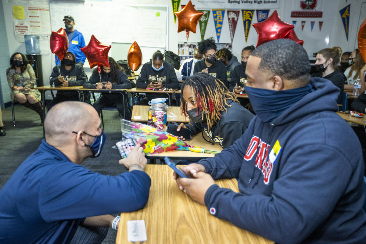 Head coach Billy Hemberger, left, talks with Spring Valley High School basketball guard Aaliyah ...
