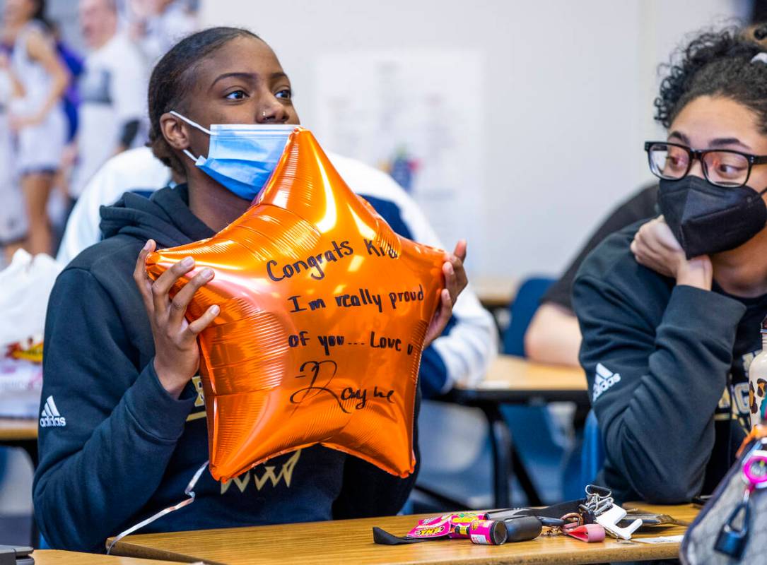 A teammate shows off her best wishes to Spring Valley High School basketball guard Aaliyah Gayl ...