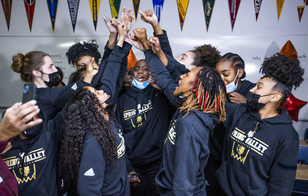 Spring Valley High School basketball guard Aaliyah Gayles, center right, jumps comes together i ...