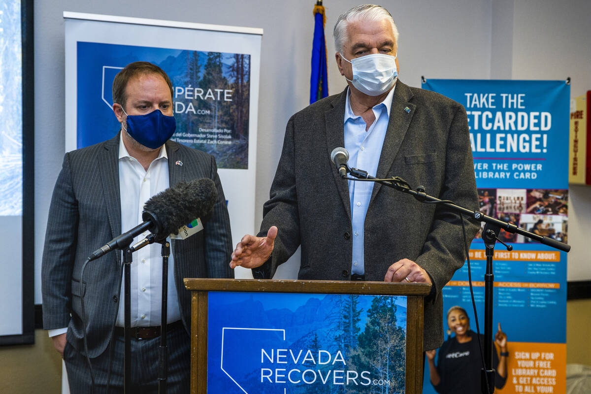 Governor Steve Sisolak, right, speaks beside Nevada Treasurer Zach Conine as they conclude the ...
