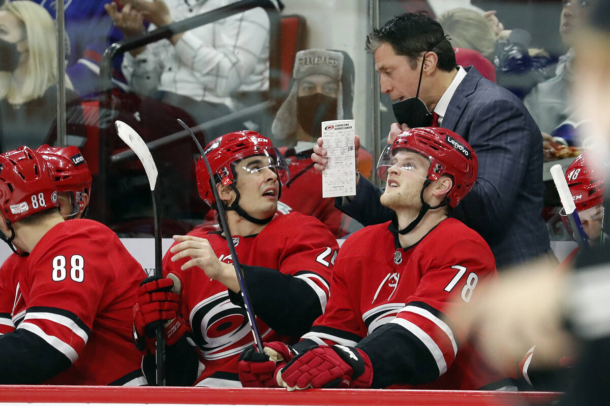 Carolina Hurricanes head coach Rod Brind'Amour, top right, speaks with Seth Jarvis, left, and S ...