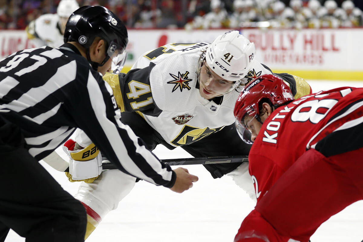 Vegas Golden Knights' Nolan Patrick (41) faces off against Carolina Hurricanes' Jesperi Kotkani ...