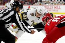 Vegas Golden Knights' Nolan Patrick (41) faces off against Carolina Hurricanes' Jesperi Kotkani ...