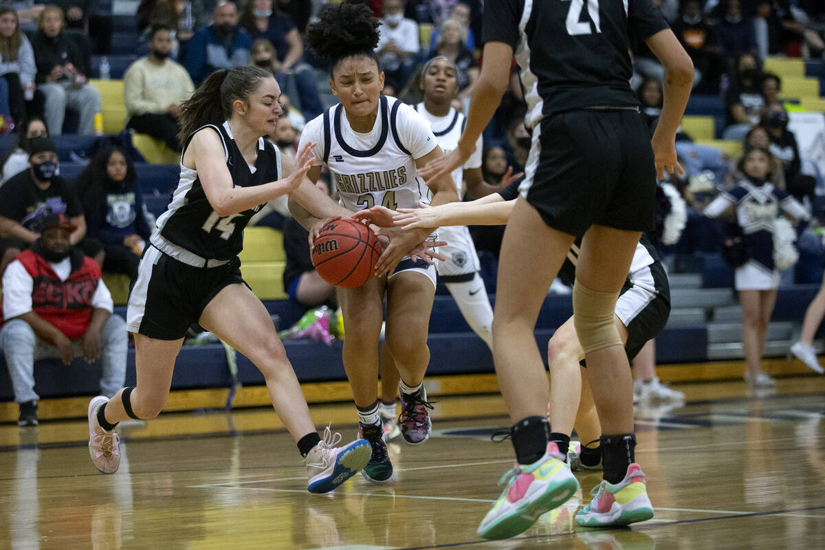 Desert Oasis’ Hailey Mannella (14) and Spring Valley’s Mia Ervin (24) fight for t ...
