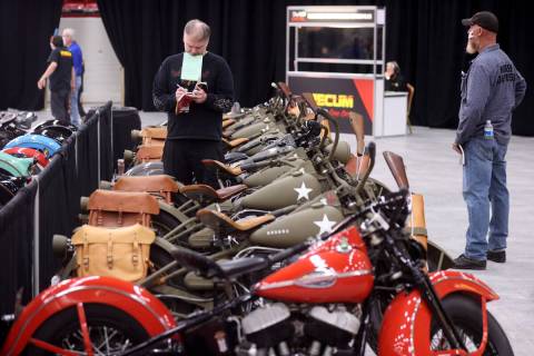 Howard Hunt of Anchorage, Alaska, checks out military motorcycles at the Mecum Auctions vintage ...