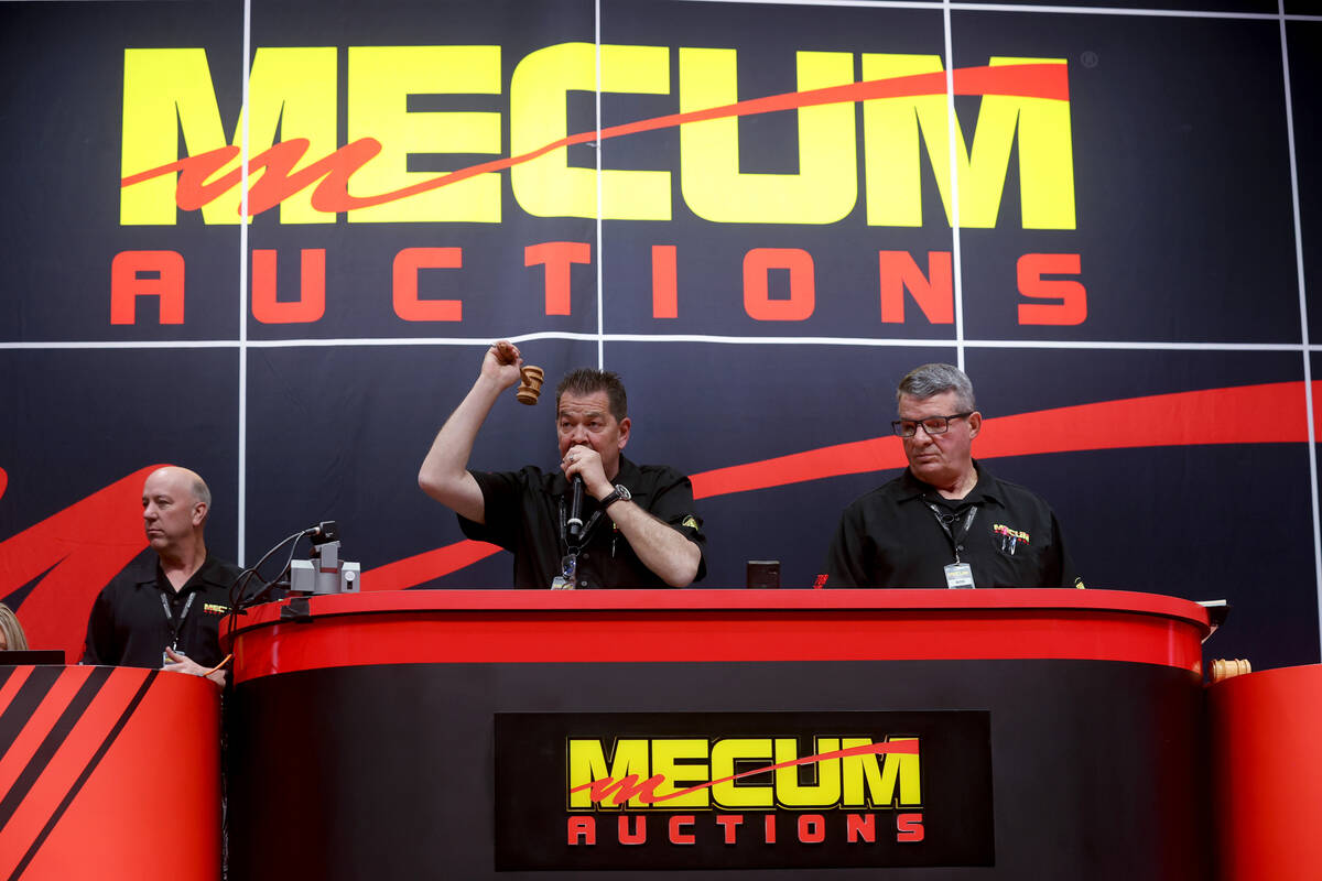 Auctioneer Jimmy Landis calls bids at the Mecum Auctions vintage and antique motorcycle auction ...