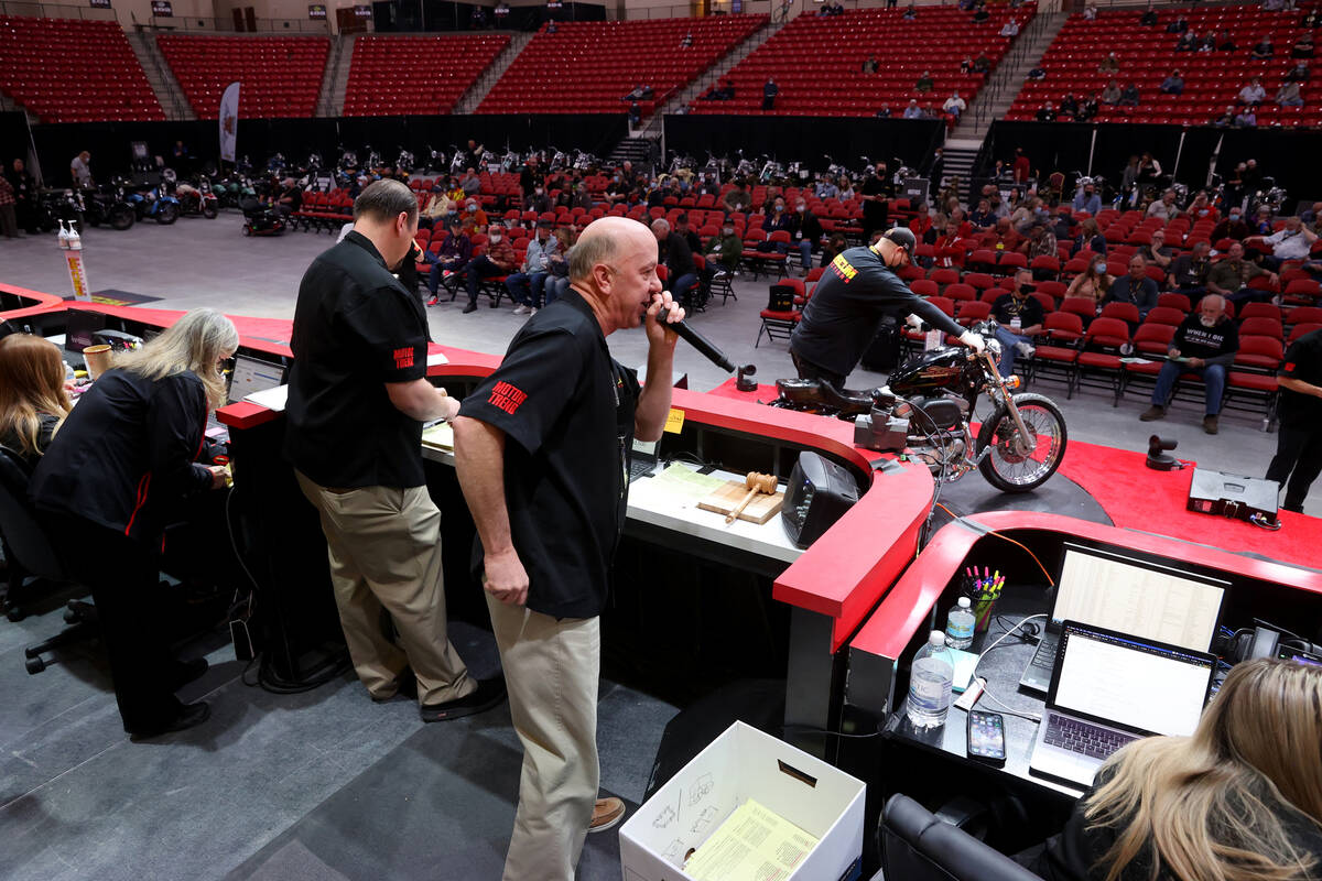 Auctioneer Russ Conklin calls bids at the Mecum Auctions vintage and antique motorcycle auction ...