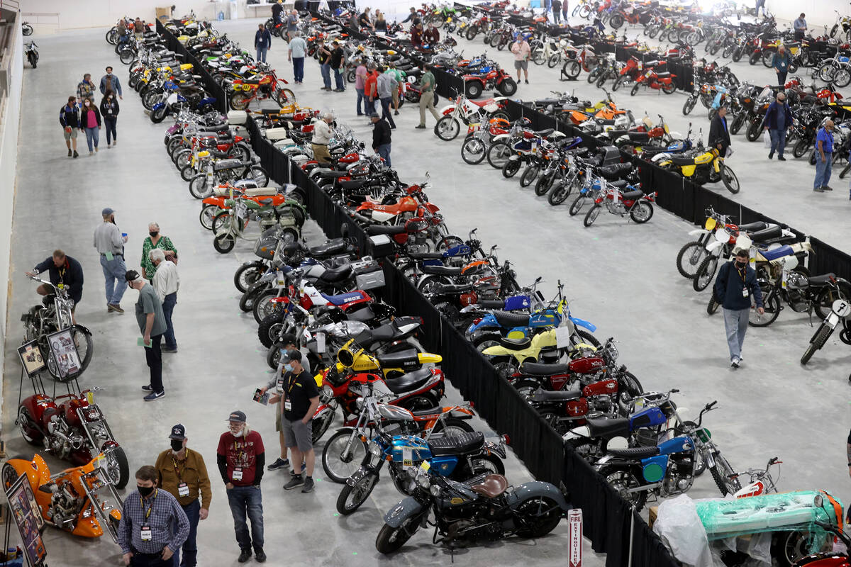 Bidders check out bikes at the Mecum Auctions vintage and antique motorcycle auction at the Sou ...