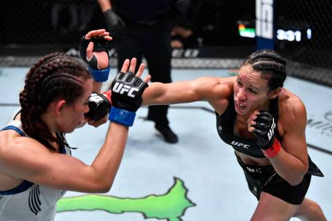 Marion Reneau punches Miesha Tate in their bantamweight bout during the UFC Fight Night event a ...