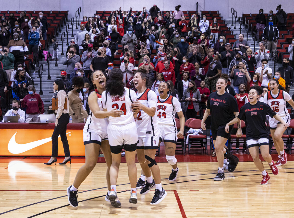 UNLV Lady Rebels guard Essence Booker (24) is mobbed by teammates after reaching 1,000 career p ...