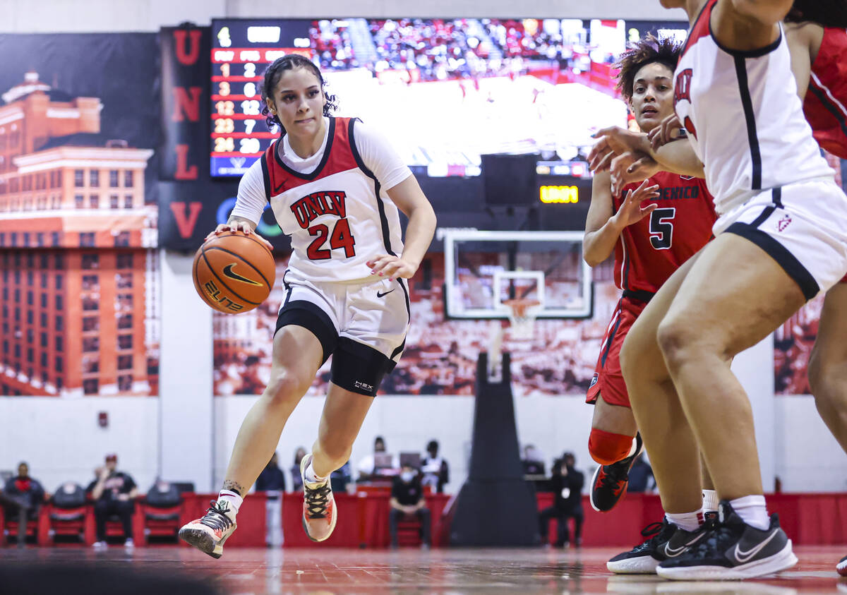 UNLV Lady Rebels guard Essence Booker (24) drives to the basket against the New Mexico Lobos du ...