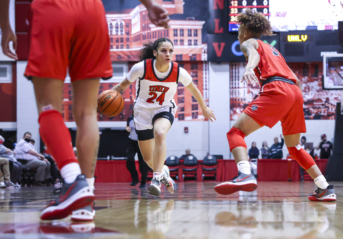 UNLV Lady Rebels guard Essence Booker (24) drives to the basket against the New Mexico Lobos du ...