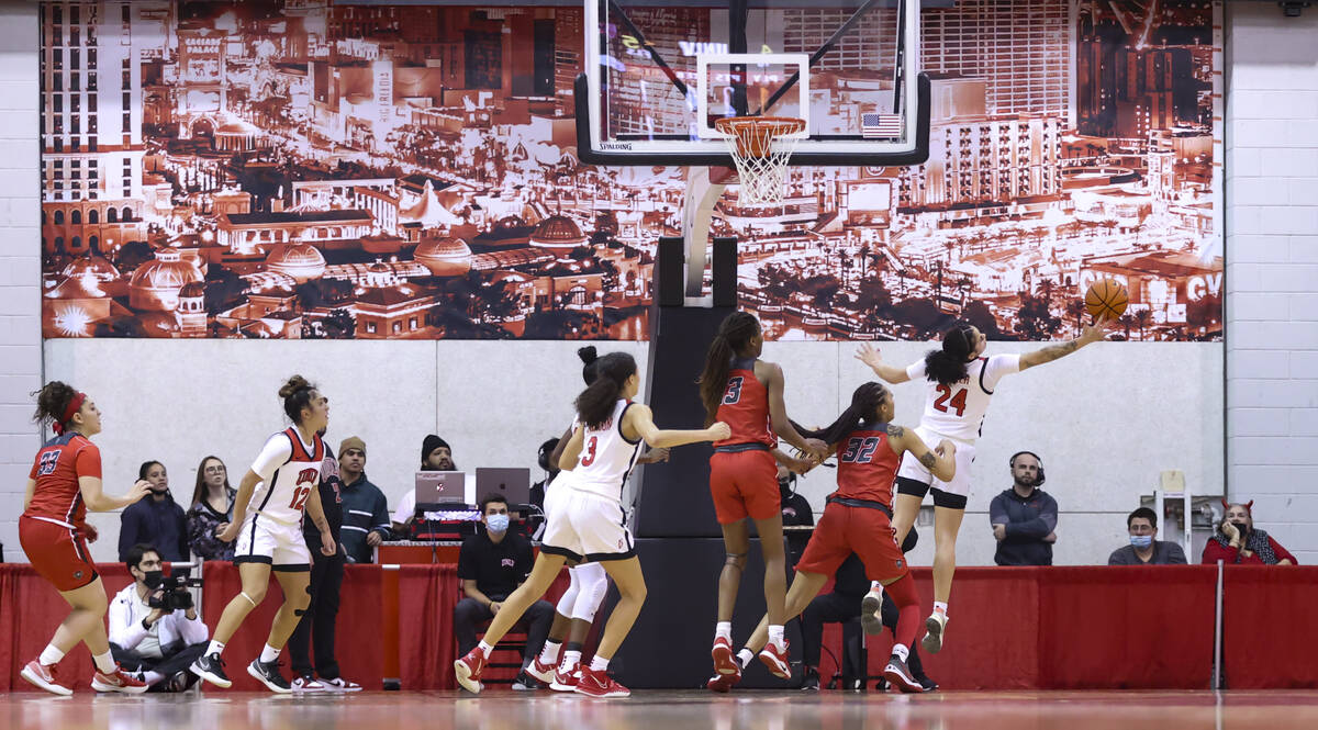 UNLV Lady Rebels guard Essence Booker (24) reaches for a rebound against the New Mexico Lobos d ...