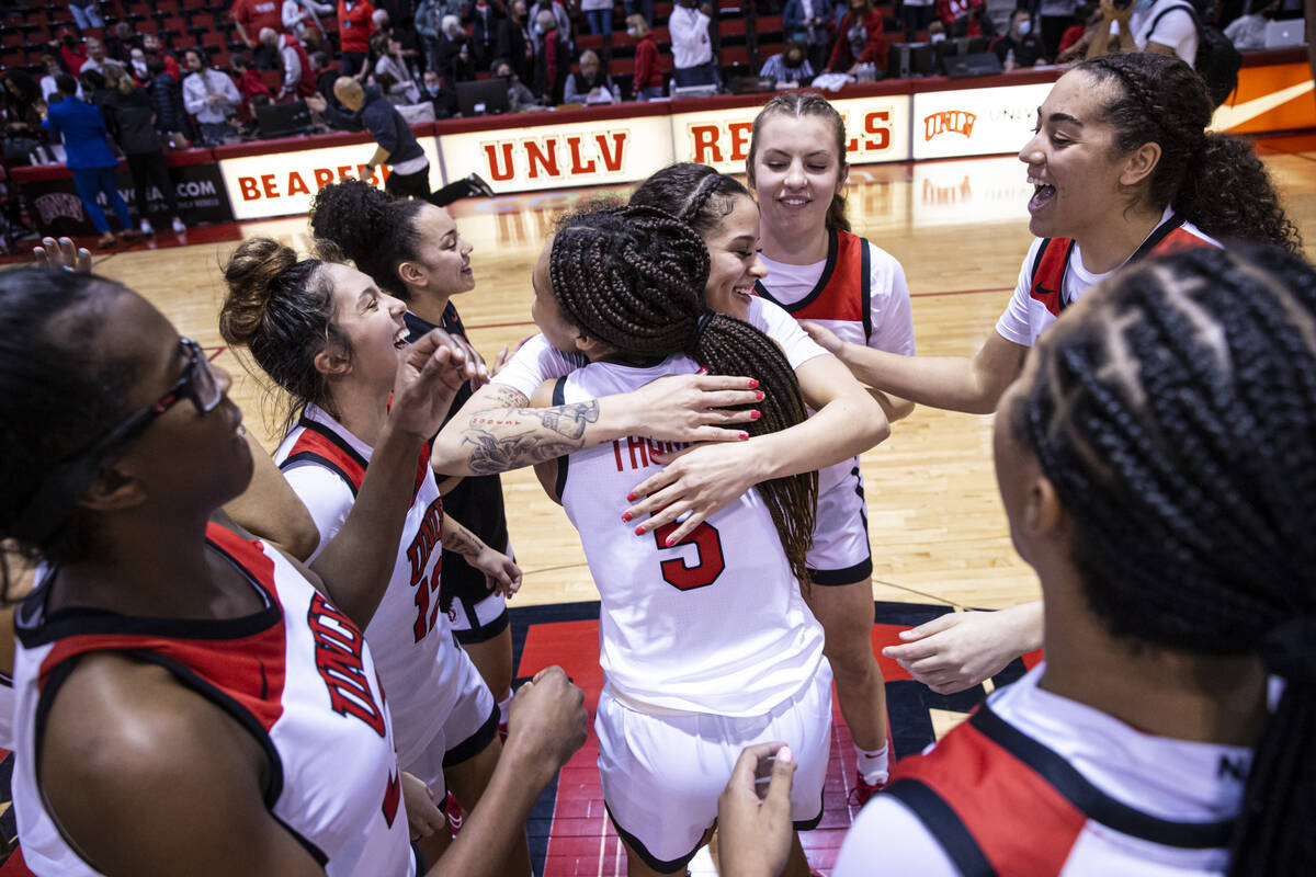 UNLV Lady Rebels guard Essence Booker gets a hug from guard Jade Thomas (5) after Booker reache ...