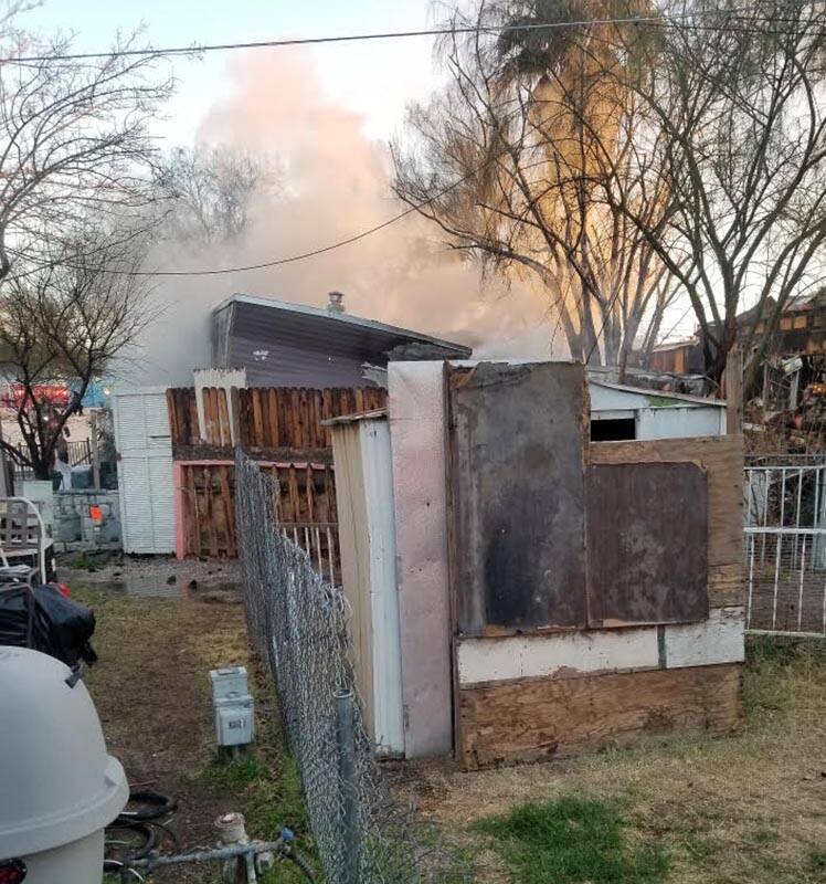 Smoke and flames coming from a mobile home in the 1300 block of South Mojave Road on Wednesday, ...