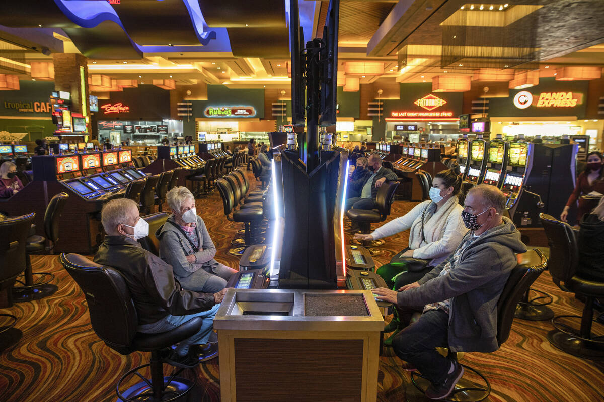 Gary Correa of Los Angeles, bottom right, joins others inn playing slots at Red Rock Casino on ...