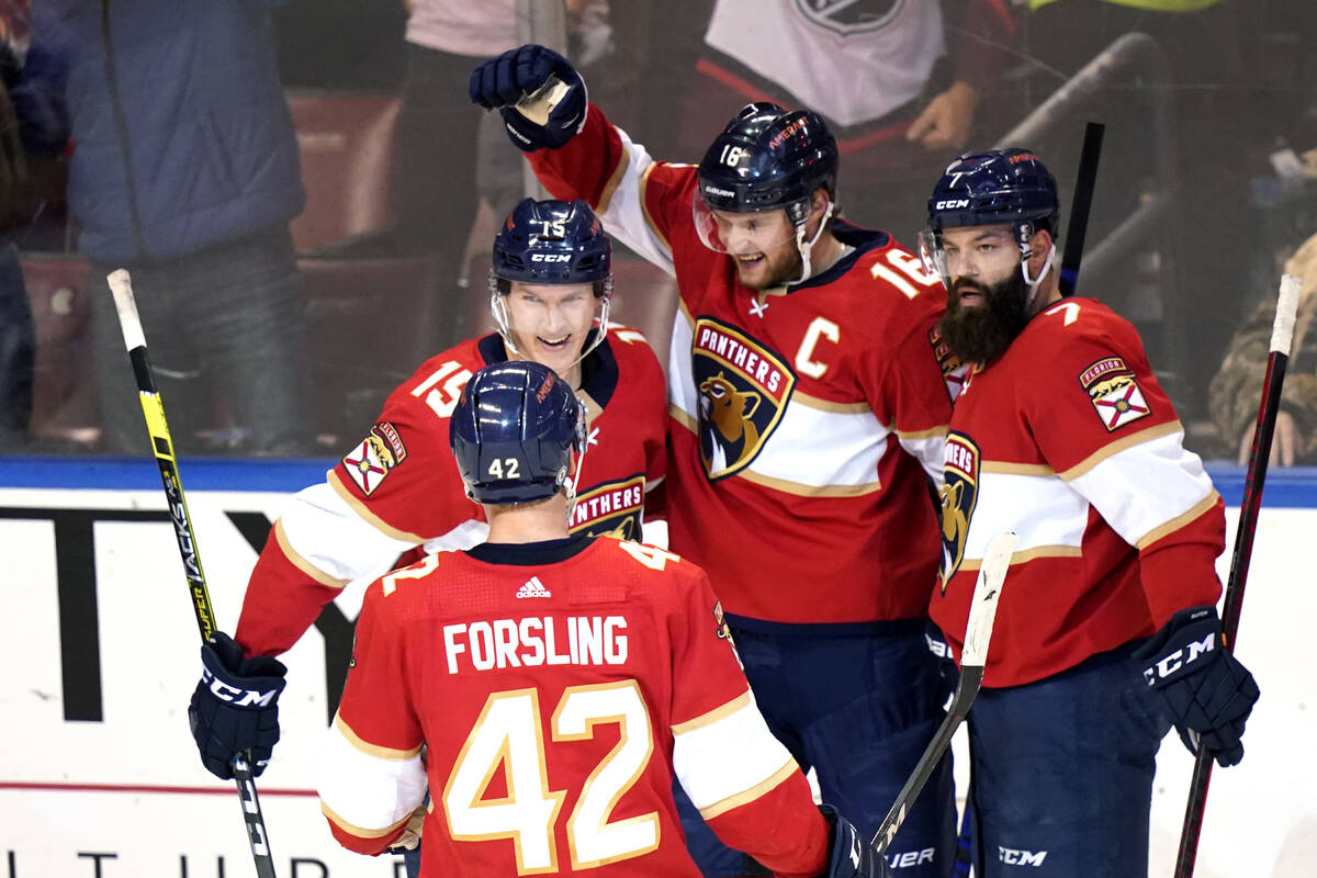 Florida Panthers center Aleksander Barkov (16) celebrates with Anton Lundell (15), Gustav Forsl ...