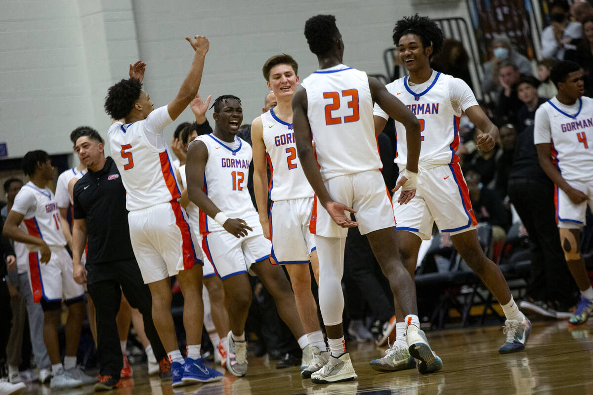 Bishop Gorman players celebrate after Chris Nwuli (23) dunked against Liberty during the first ...