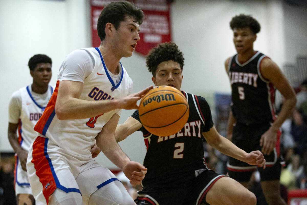 Bishop Gorman’s Ryan Abelman (0) drives around Liberty’s Angelo Kambala (2) durin ...