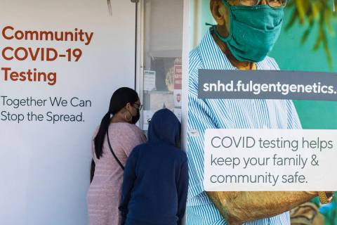 People arrive to get tested for COVID-19 outside of the West Flamingo Senior Center on Tuesday, ...