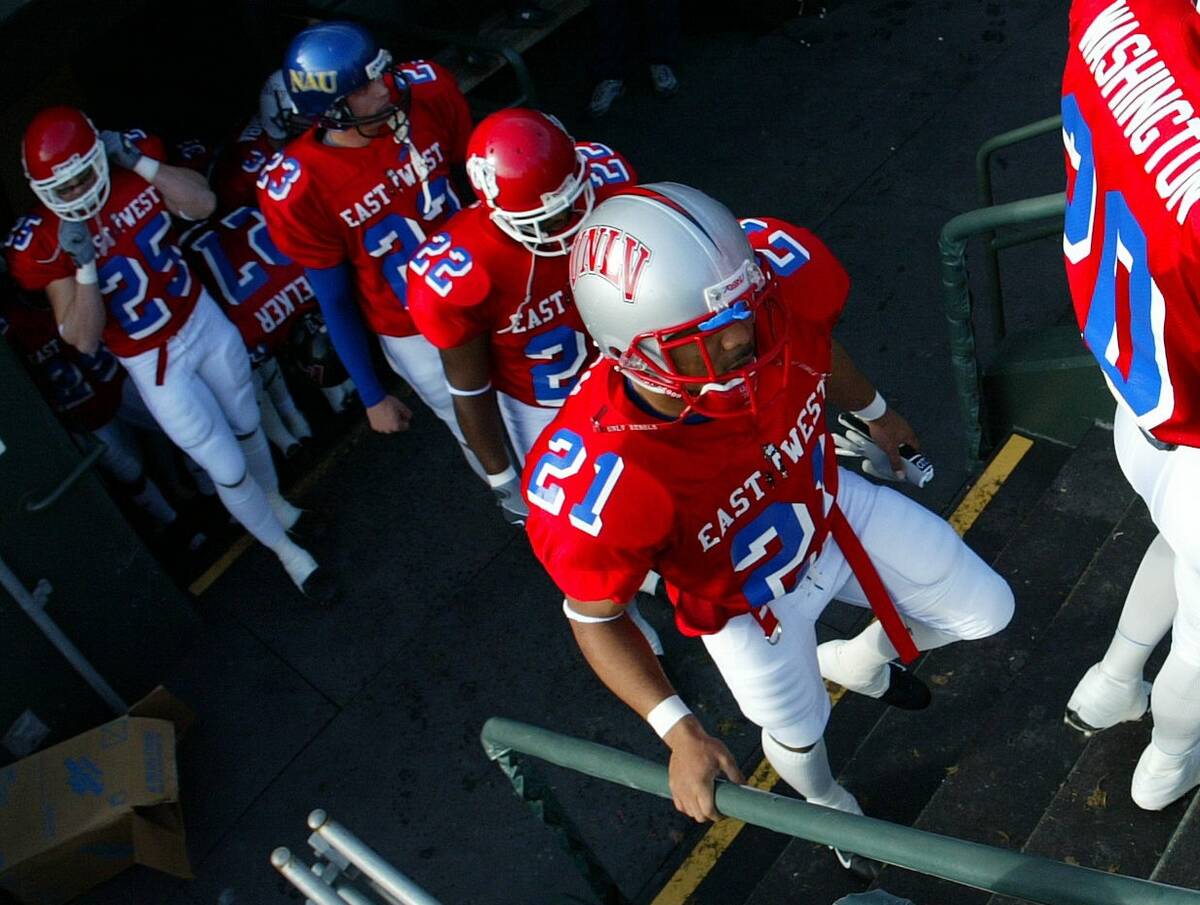 Former UNLV running back Larry Croom is shown climbing the stairs to the field to play in the 2 ...