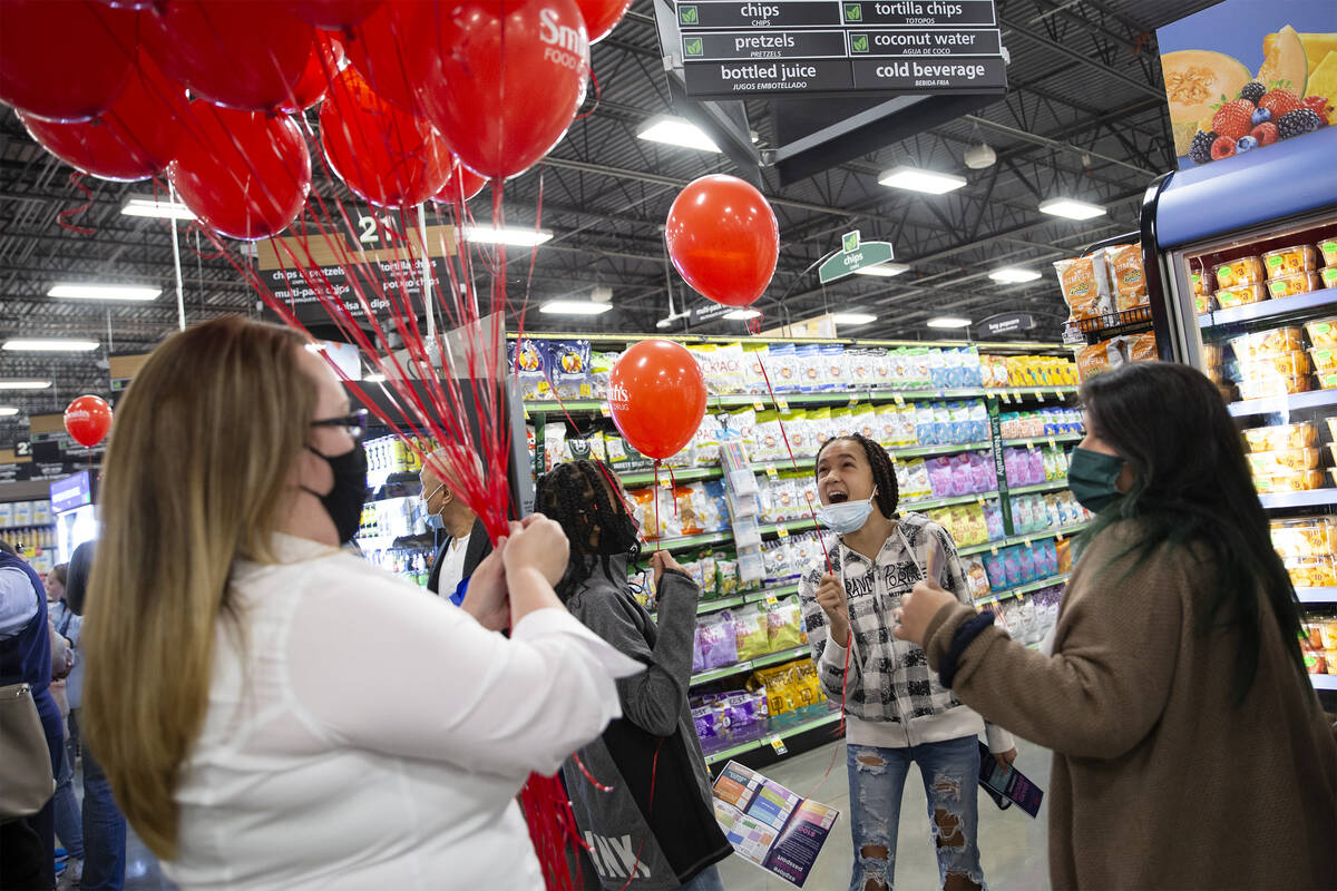 Taitum Davis, 13, second from right, reacts while getting a balloon during a preview celebratio ...