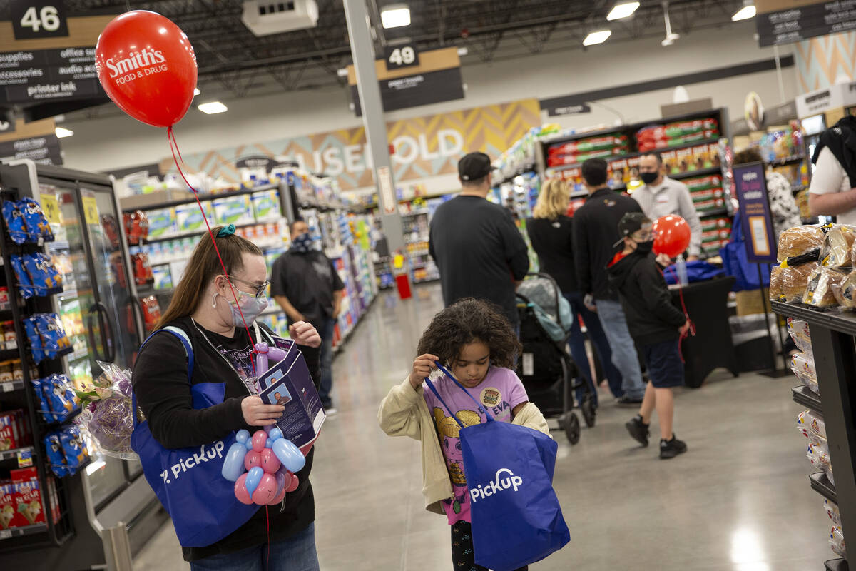 Ashlee Jones, left, a Smith’s store associate, and her daughter Rylee Jones, 8, attend a ...