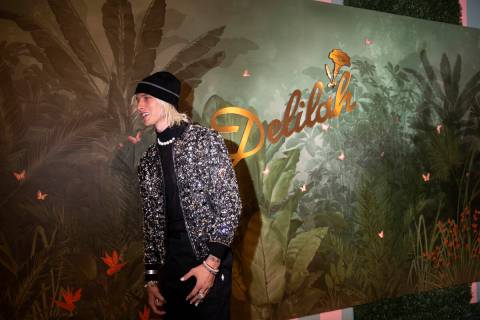 Machine Gun Kelly poses for photographers upon arrival at the grand opening party of Delilah at ...