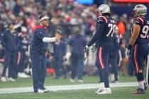 New England Patriots offensive coordinator Josh McDaniels congratulates tackle Isaiah Wynn (76) ...