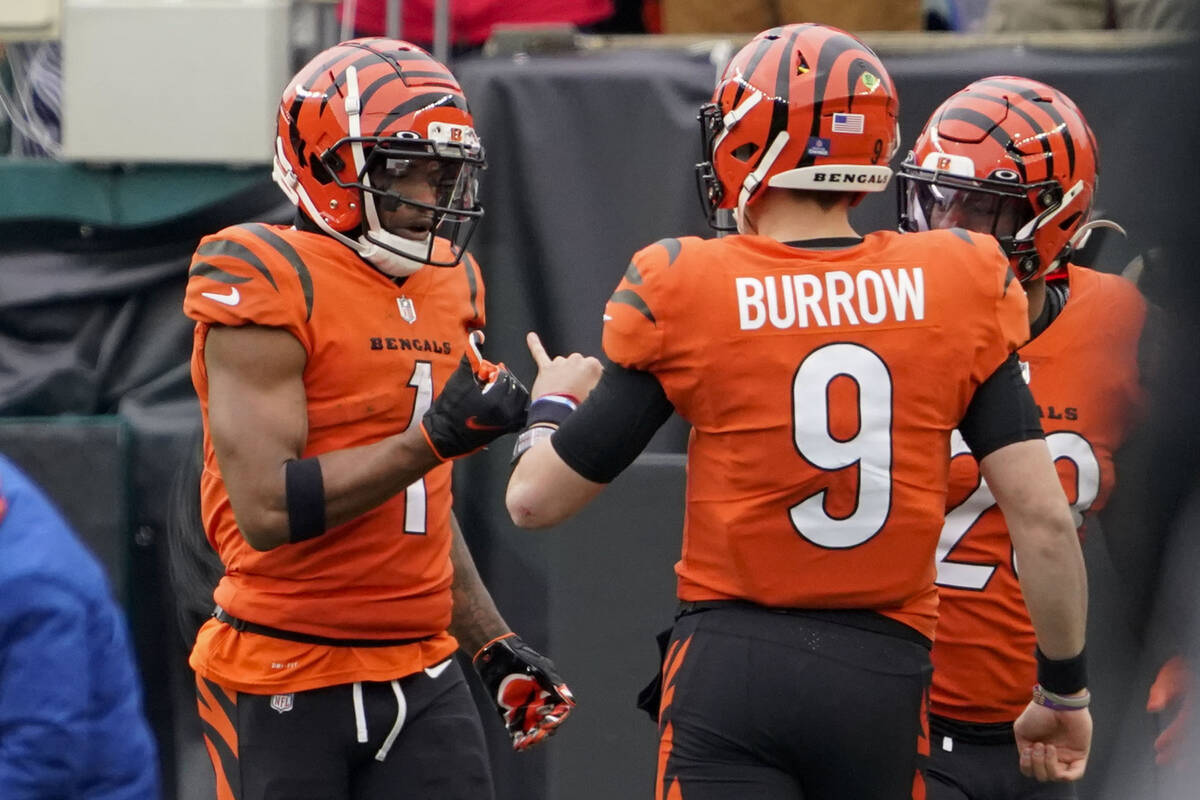 Cincinnati Bengals wide receiver Ja'Marr Chase (1) celebrates with quarterback Joe Burrow (9) a ...