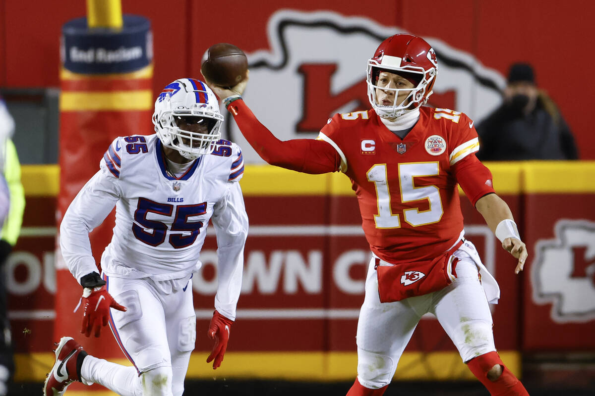 Kansas City Chiefs quarterback Patrick Mahomes (15) throws a pass as Buffalo Bills defensive en ...