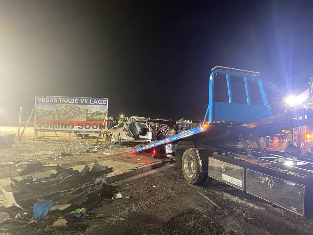 Authorities get set to tow a vehicle involved a six-car crash at the scene of a fatal crash on ...
