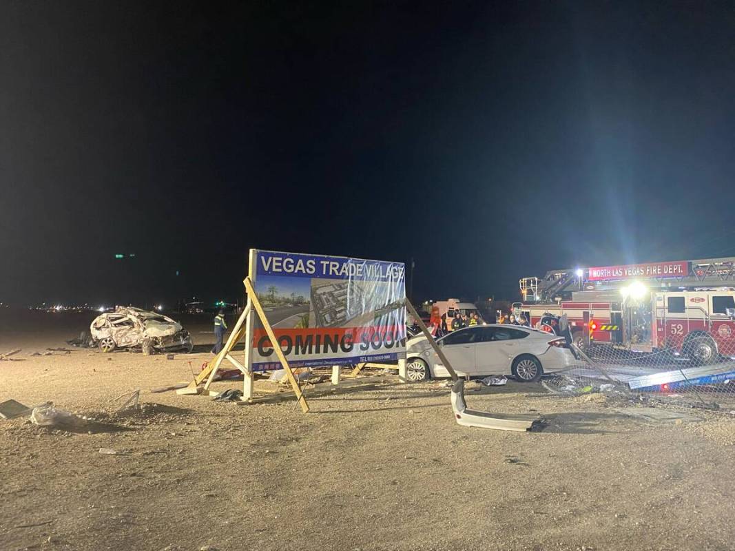 Emergency personnel work at the scene of a six-vehicle crash on West Cheyenne Avenue in North L ...