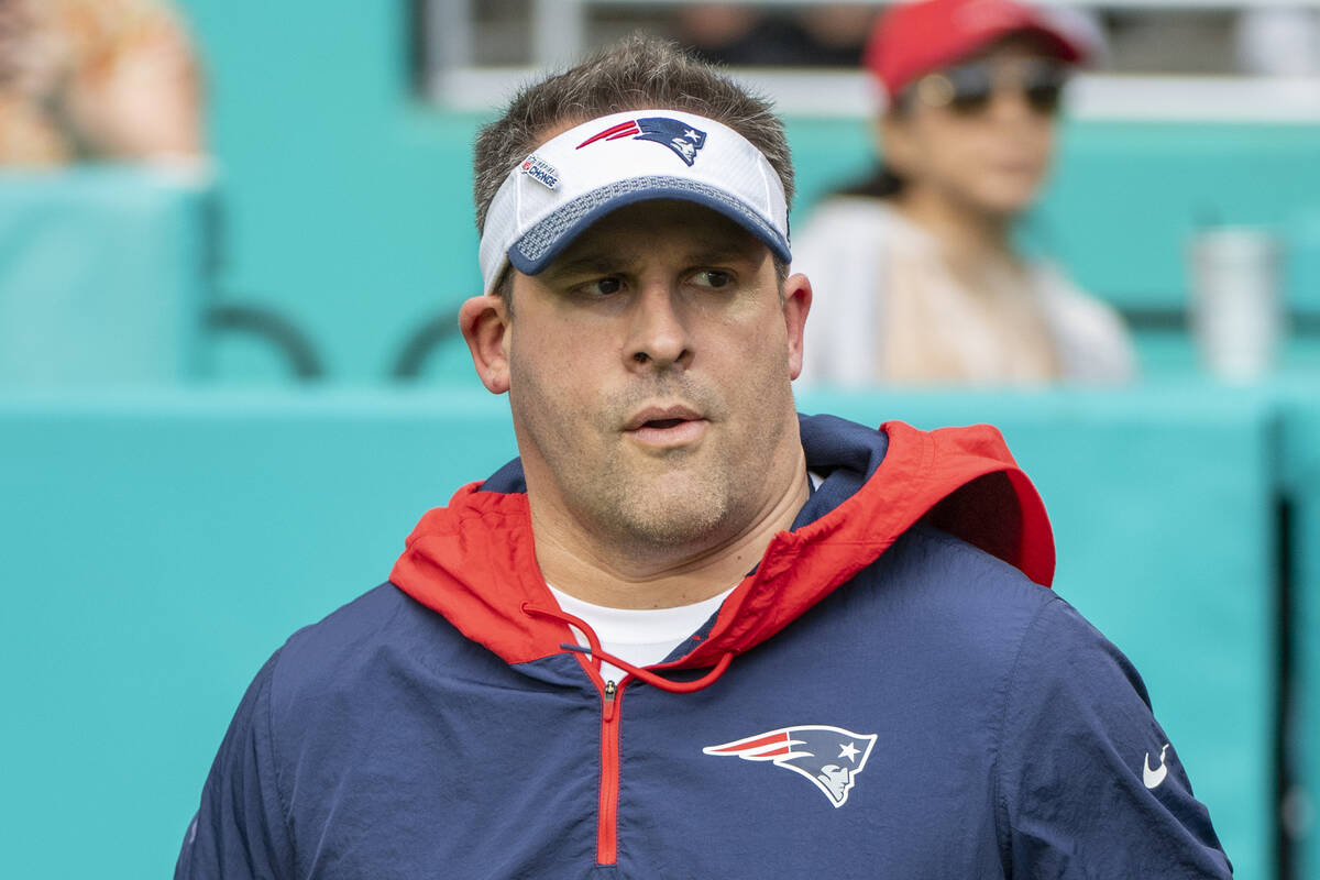 New England Patriots offensive coordinator and quarterbacks coach Josh McDaniels jogs on to the ...